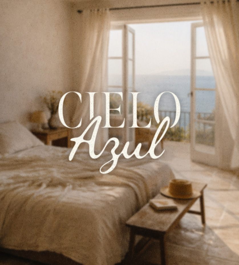 Cielo Azul boutique hotel branding: sunlit guest bedroom opening onto a sea-view balcony, with the Cielo Azul logo